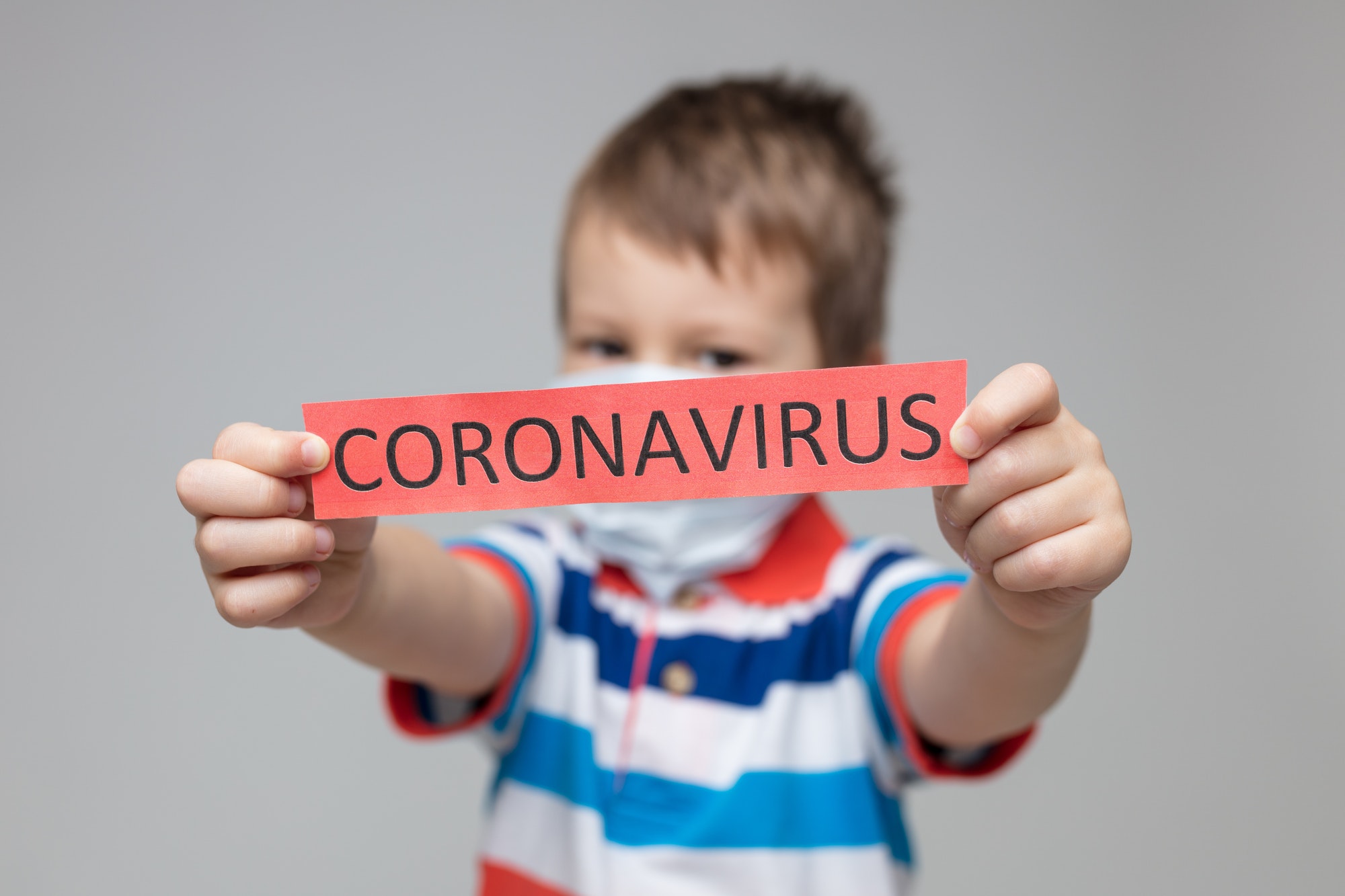 Young child wearing a respiratory mask as a prevention against the Coronavirus Covid-19